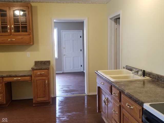 kitchen with a textured ceiling, dark hardwood / wood-style floors, and sink