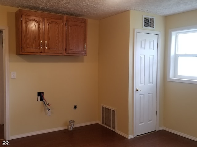 washroom with a textured ceiling, electric dryer hookup, and dark hardwood / wood-style floors