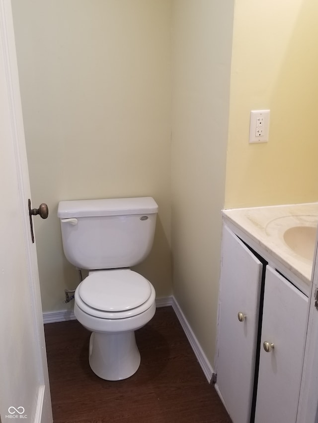 bathroom with vanity, wood-type flooring, and toilet