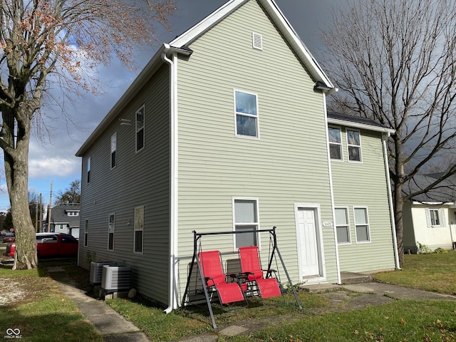 back of house with central AC