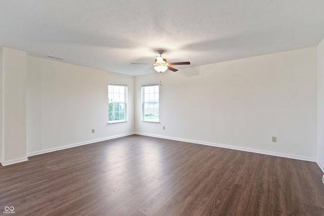 unfurnished room with a textured ceiling, ceiling fan, and dark hardwood / wood-style floors