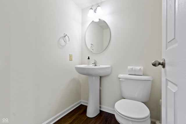 bathroom with sink, wood-type flooring, and toilet