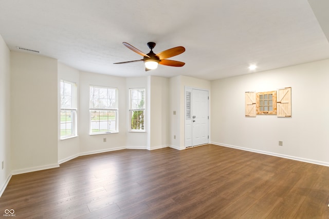 spare room with ceiling fan and dark wood-type flooring