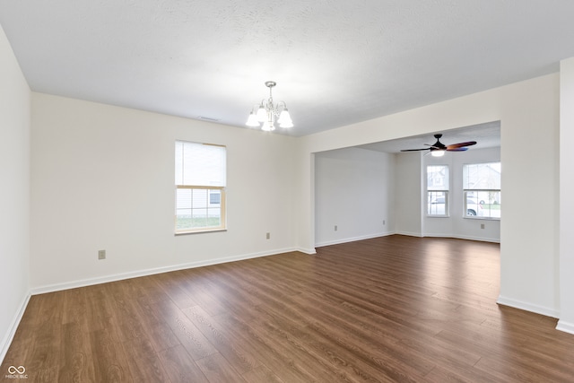 unfurnished room featuring a textured ceiling, ceiling fan with notable chandelier, and dark hardwood / wood-style floors