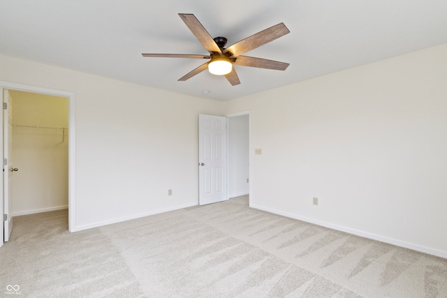 unfurnished room with ceiling fan and light carpet