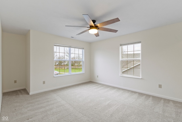 carpeted empty room featuring ceiling fan