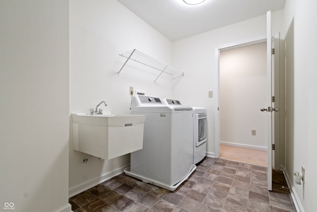 washroom featuring washing machine and dryer and sink