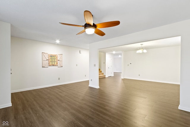 unfurnished living room featuring dark hardwood / wood-style floors and ceiling fan with notable chandelier