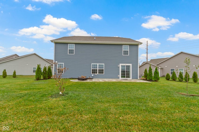 rear view of house with a lawn and a patio