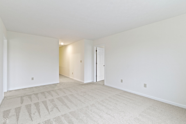 unfurnished room featuring light colored carpet