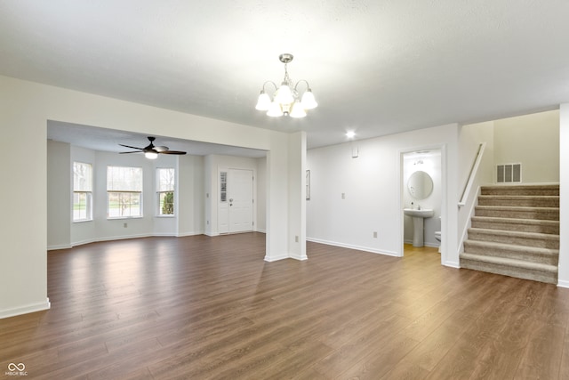 unfurnished living room featuring dark hardwood / wood-style floors, sink, and ceiling fan with notable chandelier