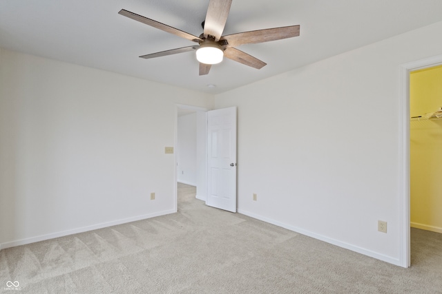 spare room with light carpet and ceiling fan