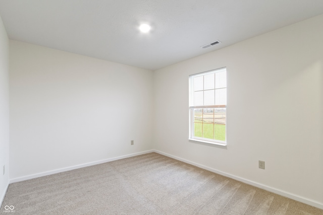 spare room with light colored carpet