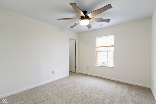 unfurnished room featuring ceiling fan and light carpet