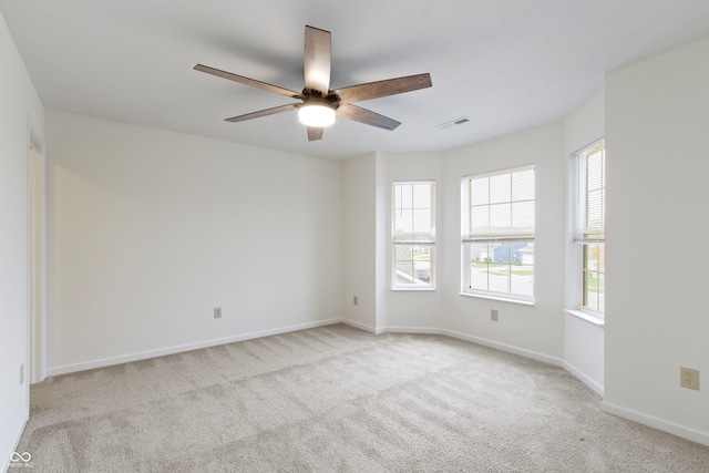 empty room with light carpet and ceiling fan