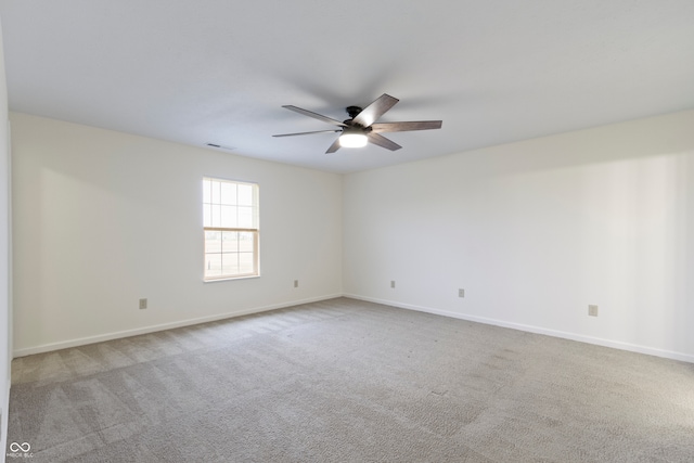 unfurnished room featuring ceiling fan and light carpet