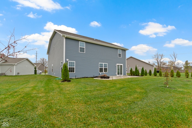 back of property featuring a yard and a patio