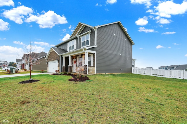 view of front facade featuring covered porch, a front yard, and a garage