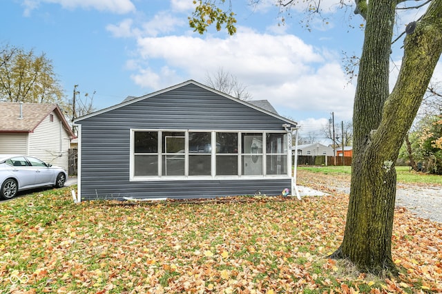 view of property exterior with a sunroom