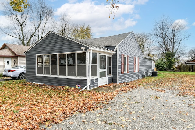 view of side of property with central AC and a sunroom