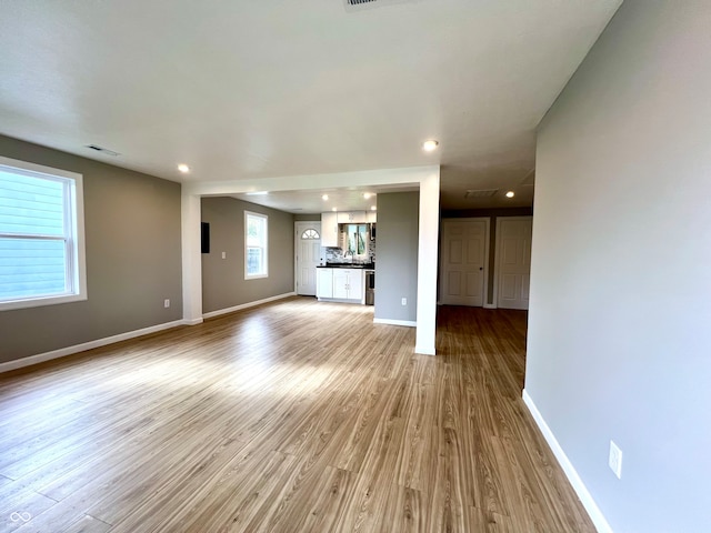 unfurnished living room with light hardwood / wood-style flooring