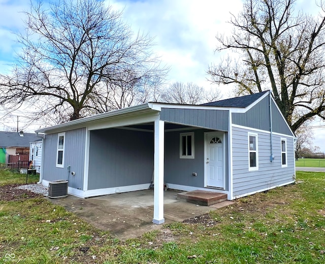 exterior space featuring a lawn and cooling unit