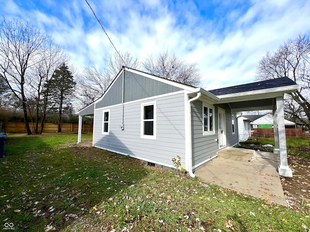 view of side of home with a lawn