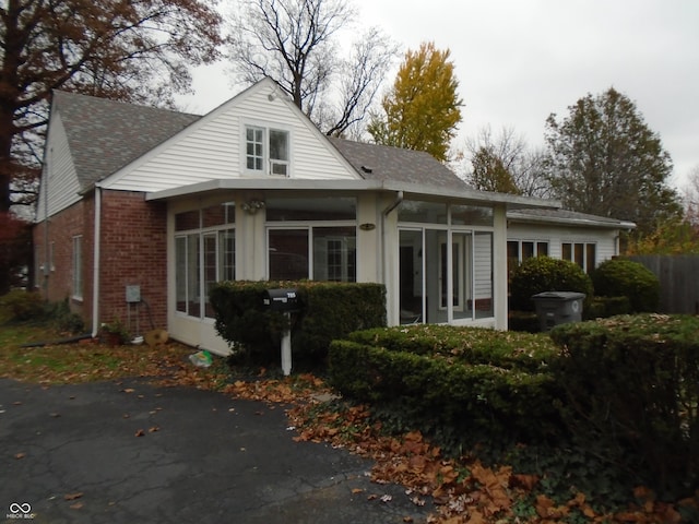 rear view of property with a sunroom