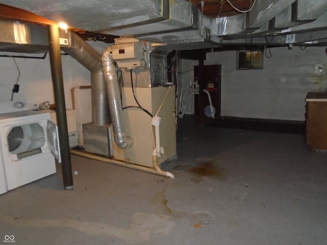 basement with heating unit and washer / dryer