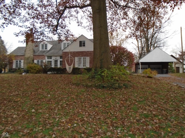 705 W 6th St, Seymour, IN 47274 - view of front of home featuring a garage and a chimney