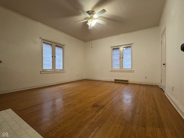 spare room featuring hardwood / wood-style flooring, ceiling fan, crown molding, and french doors