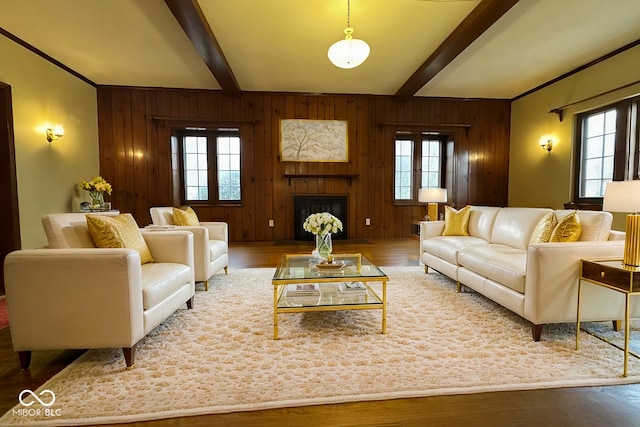 705 W 6th St, Seymour, IN 47274 - living room with wooden walls, wood finished floors, beamed ceiling, and a fireplace