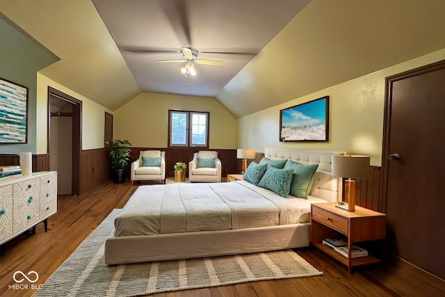 705 W 6th St, Seymour, IN 47274 - bedroom featuring wainscoting, wood finished floors, vaulted ceiling, and ceiling fan