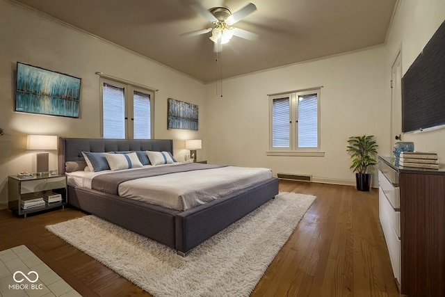 705 W 6th St, Seymour, IN 47274 - bedroom with dark wood-style flooring, multiple windows, and baseboards
