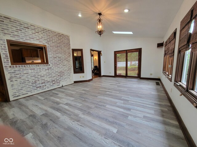 705 W 6th St, Seymour, IN 47274 - unfurnished living room featuring lofted ceiling, wood finished floors, baseboards, and recessed lighting