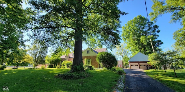 705 W 6th St, Seymour, IN 47274 - obstructed view of property featuring a garage, a front lawn, and brick siding