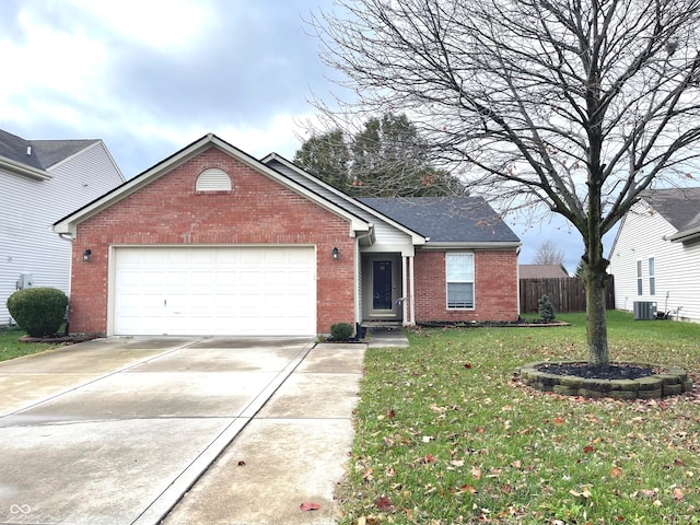 view of front of property with a front yard, central AC, and a garage