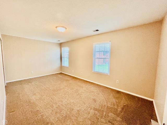 unfurnished room with carpet flooring