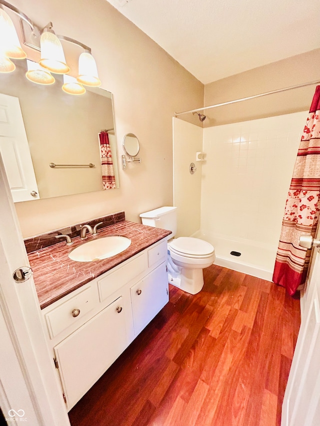 bathroom with curtained shower, hardwood / wood-style floors, vanity, and toilet