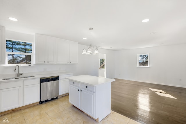 kitchen with dishwasher, white cabinets, light wood-type flooring, decorative light fixtures, and a kitchen island