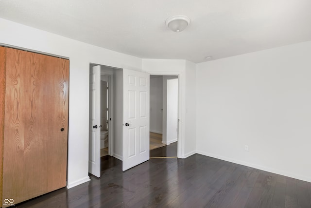 unfurnished bedroom featuring dark hardwood / wood-style flooring and a closet