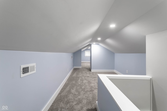 additional living space featuring carpet flooring and vaulted ceiling