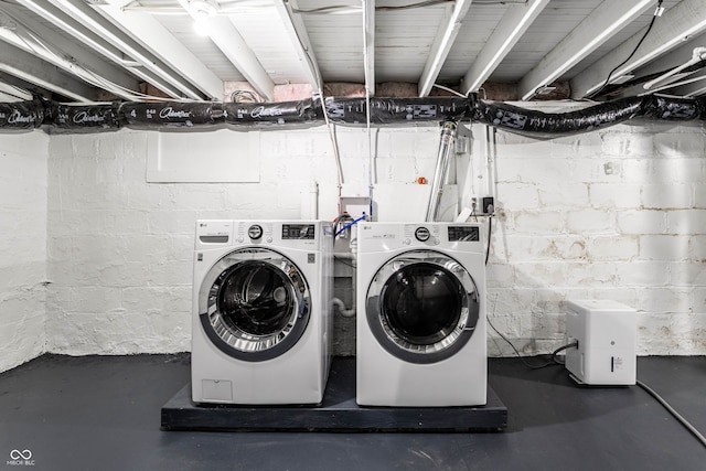 clothes washing area featuring washer and clothes dryer