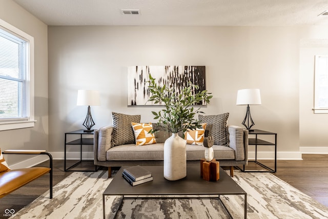 sitting room with hardwood / wood-style floors and a textured ceiling