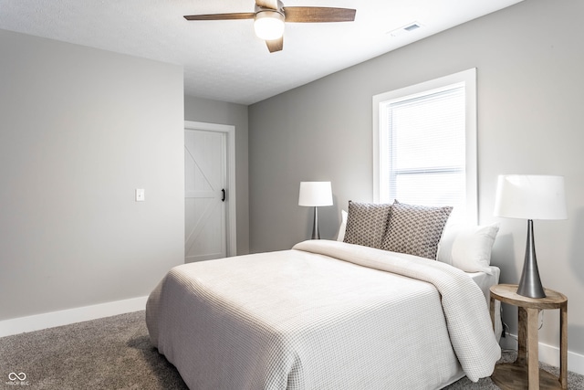 bedroom with carpet floors, ceiling fan, and a barn door