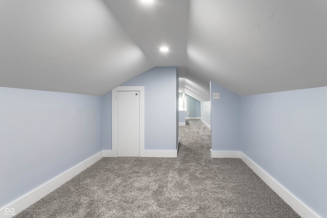 additional living space with carpet and vaulted ceiling