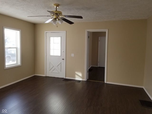 foyer with a textured ceiling, dark hardwood / wood-style flooring, and ceiling fan