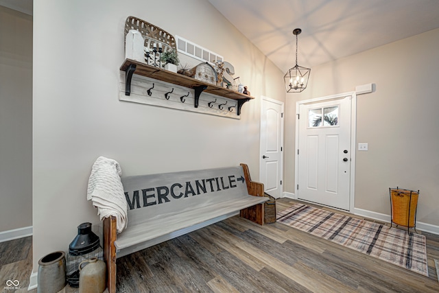 mudroom featuring a chandelier and dark wood-type flooring