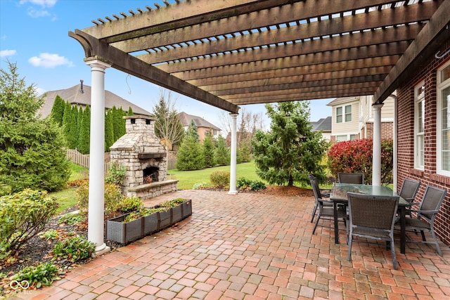 view of patio / terrace featuring an outdoor stone fireplace, fence, and outdoor dining area