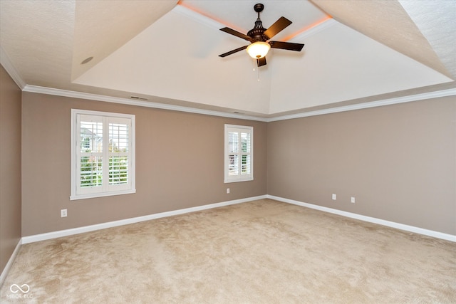 spare room featuring carpet floors, a ceiling fan, ornamental molding, and a wealth of natural light